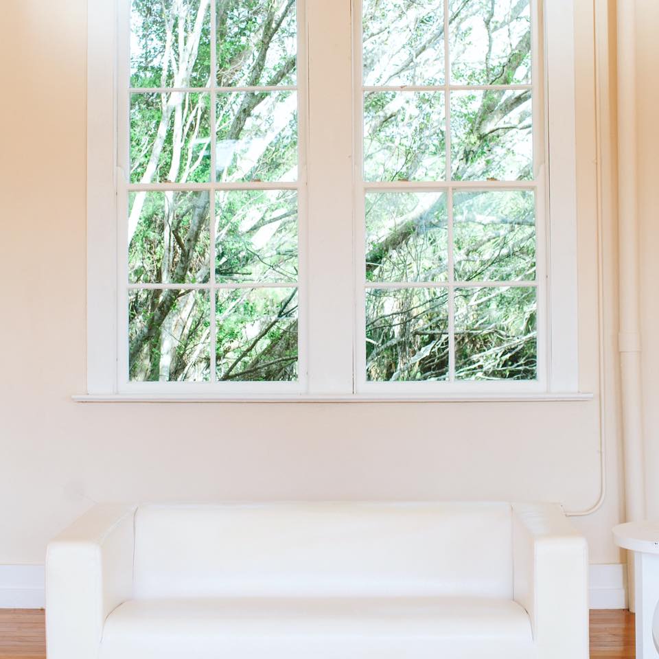 window overlooking lush green trees