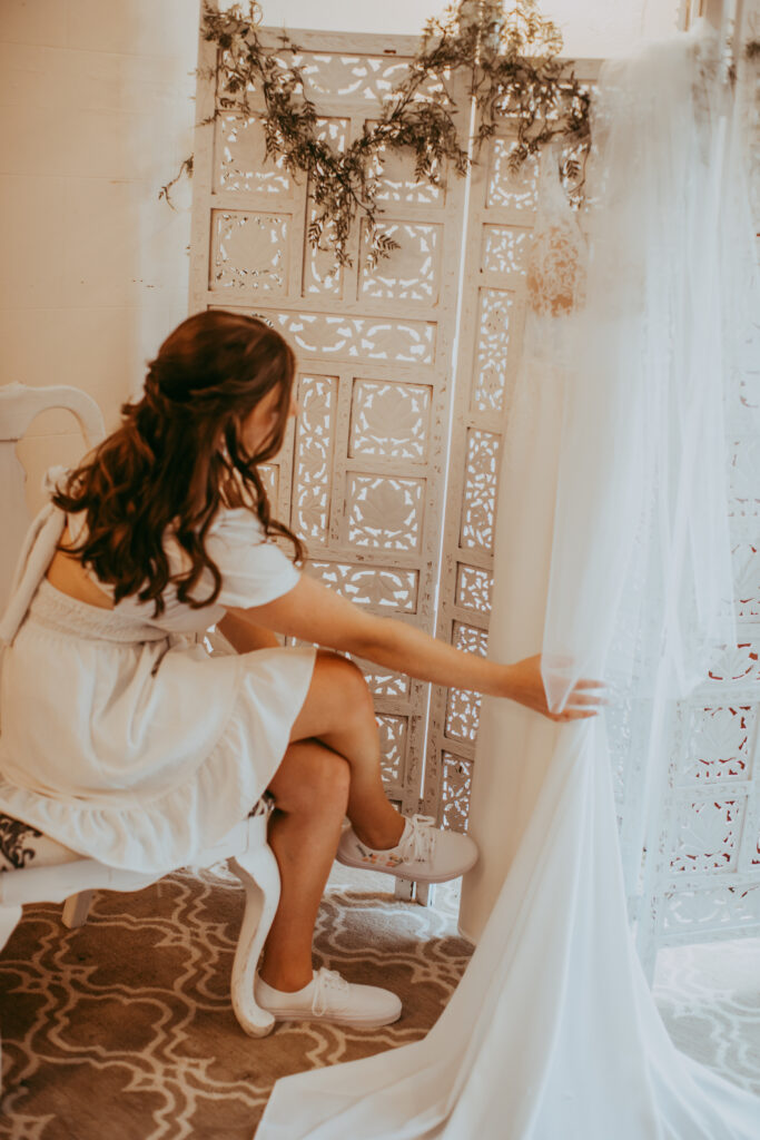 bride looking at her wedding gown