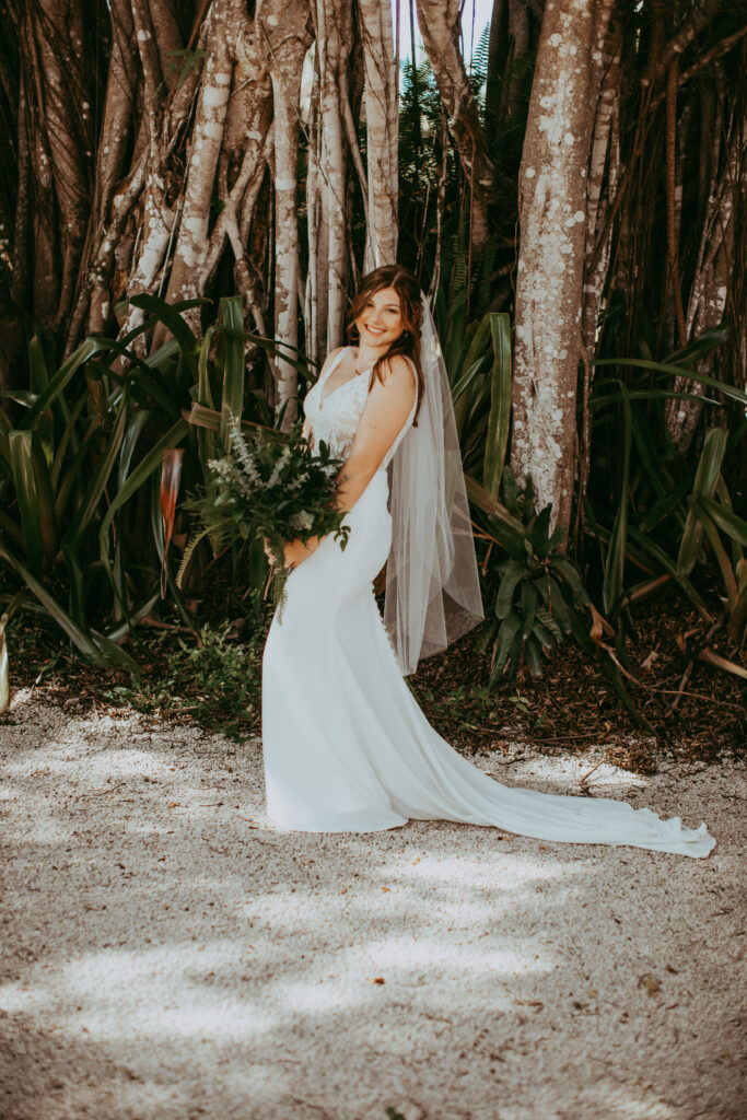 bride smiling under trees