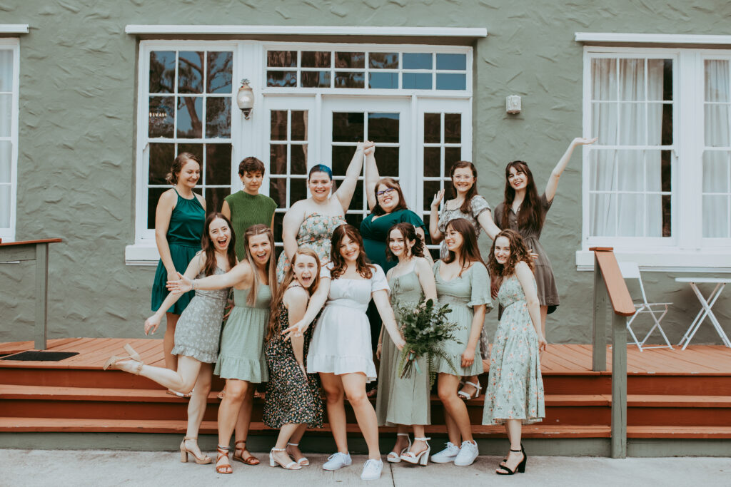 bride smiling with a group of female wedding guests