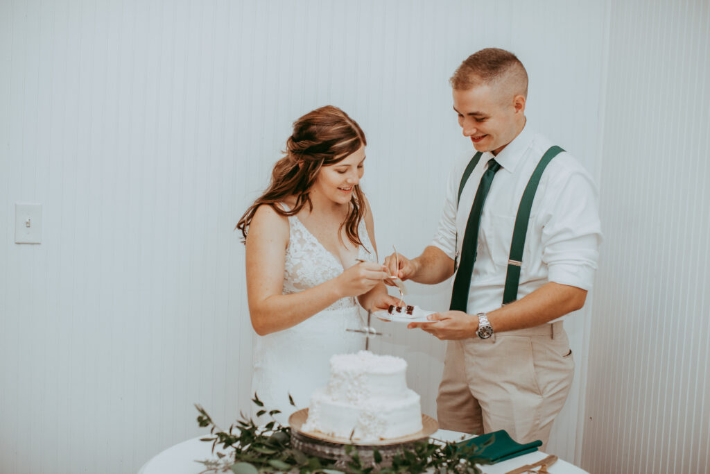 bride and groom eating wedding cake