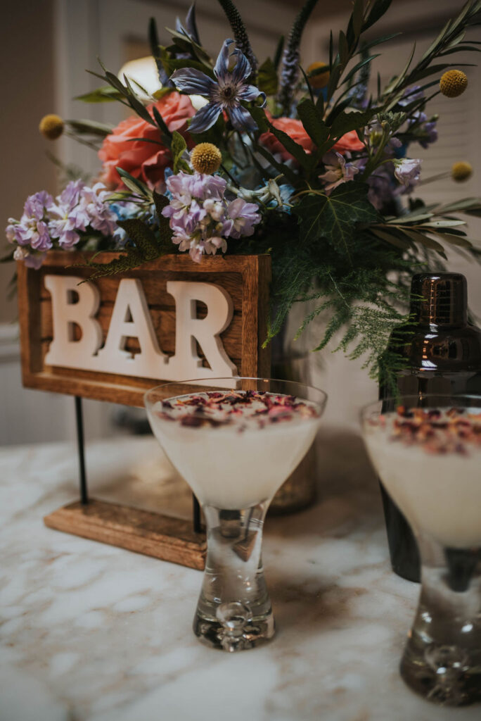 wedding cocktails next to bar sign