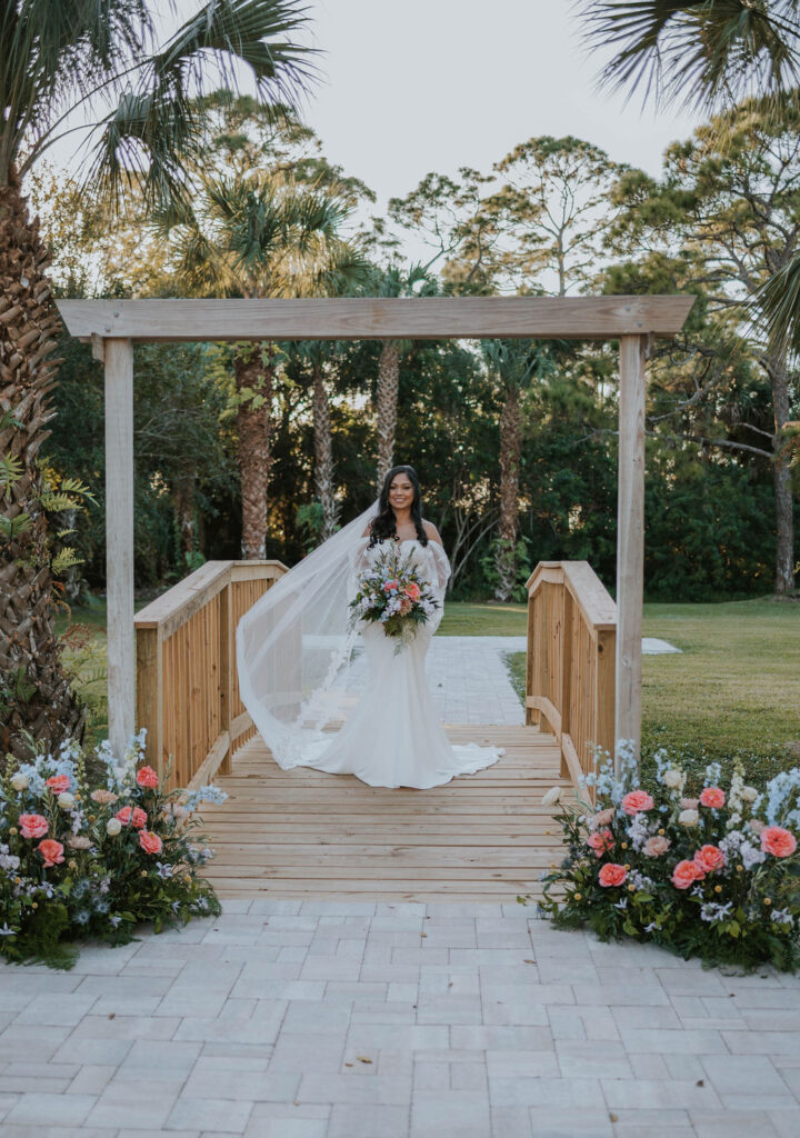 bridal portrait on bridge with spring flowers