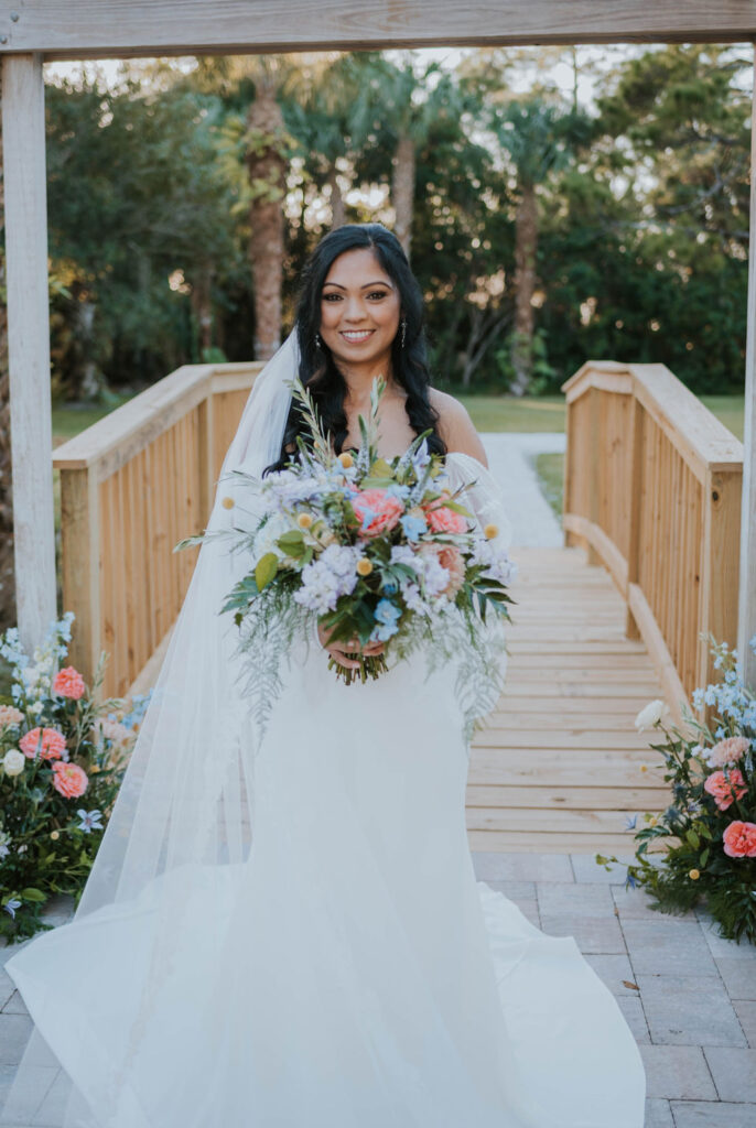 smiling bride holding bridal bouquet
