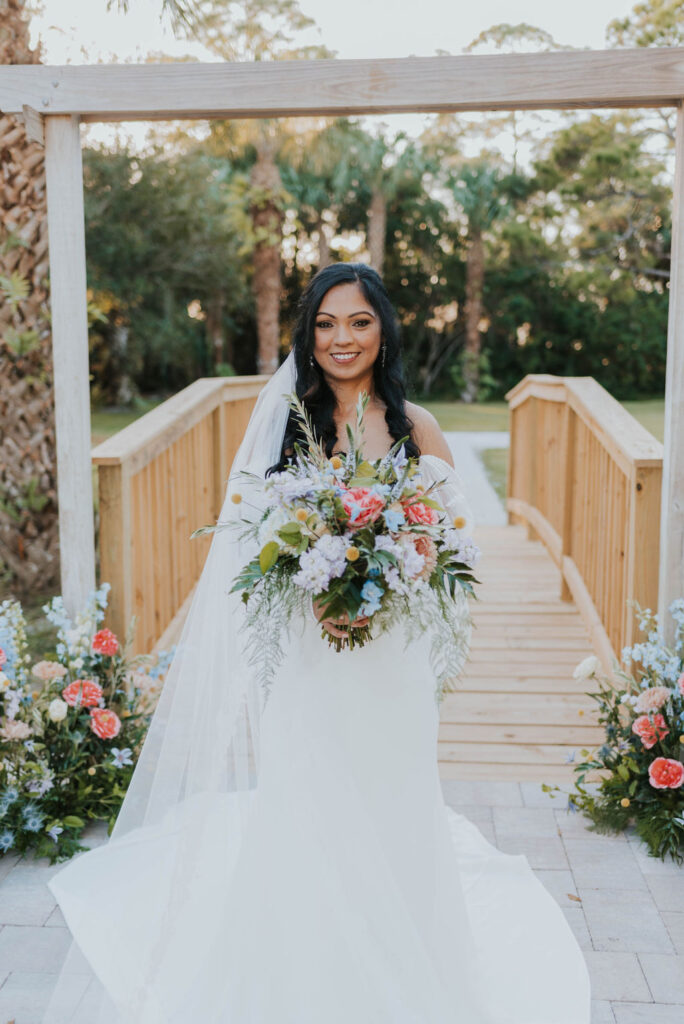 bride holding pink spring wedding bouquet