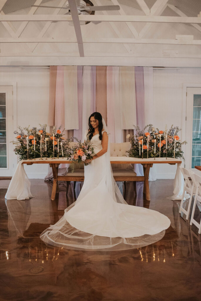 bride with long veil and train in wedding reception venue