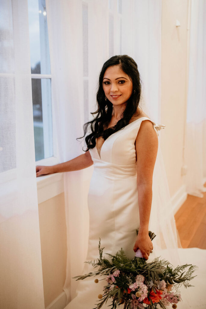 bride standing in windows